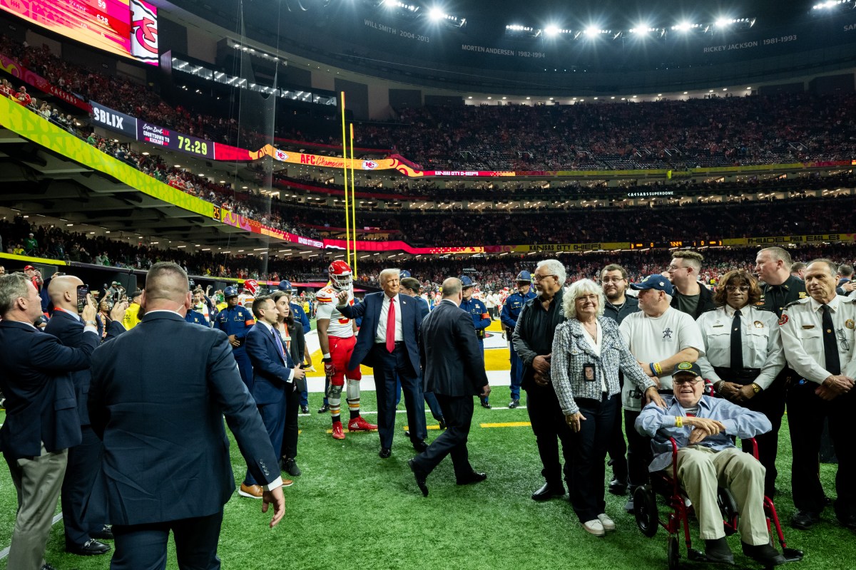 President Donald Trump greets honorary coin toss participants, including family members of the victims from the New Years terrorist attack, members of the New Orleans Police Department and emergency personnel at Caesars Superdome in New Orleans, Louisiana, Sunday, February 9, 2025, before the start of Superbowl LIX between the Philadelphia Eagles and the Kansas City Chiefs. (Official White House photo by Daniel Torok)