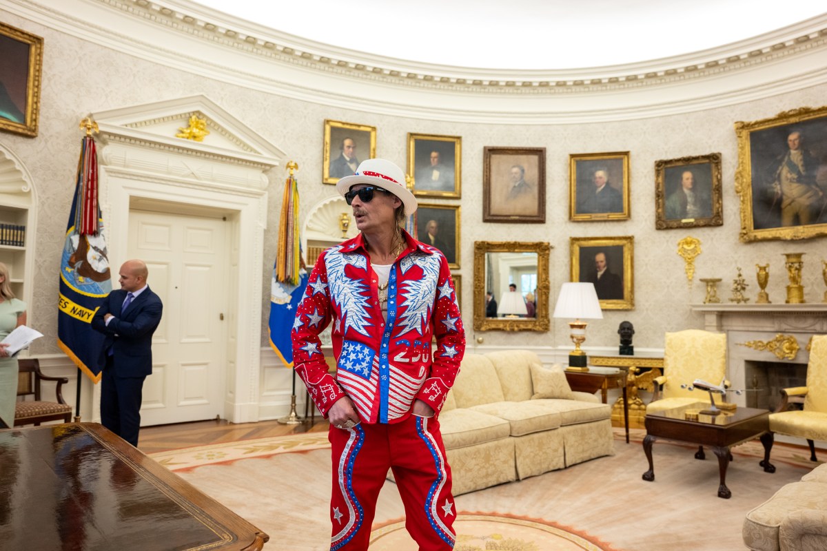 President Donald Trump signs an Executive Order alongside Kid Rock in the Oval Office, Monday, March 31, 2025. (Official White House Photo by Molly Riley)