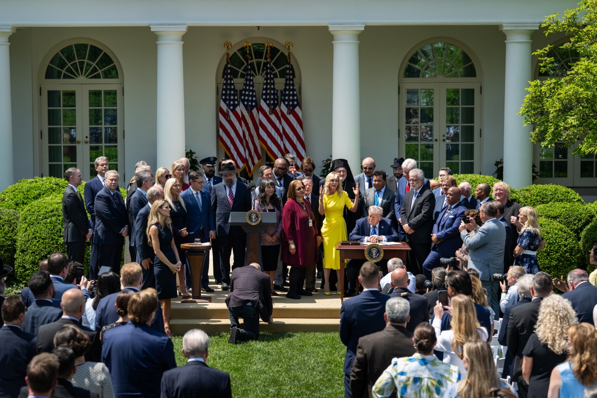 President Donald Trump prepares to sign an Executive Order alongside religious leaders at a National Day of Prayer event, Thursday, May 1, 2025, in the White House Rose Garden. (Official White House Photo by Molly Riley)