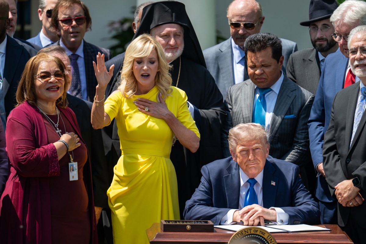 President Donald Trump prepares to sign an Executive Order alongside religious leaders at a National Day of Prayer event, Thursday, May 1, 2025, in the White House Rose Garden. (Official White House Photo by Molly Riley)