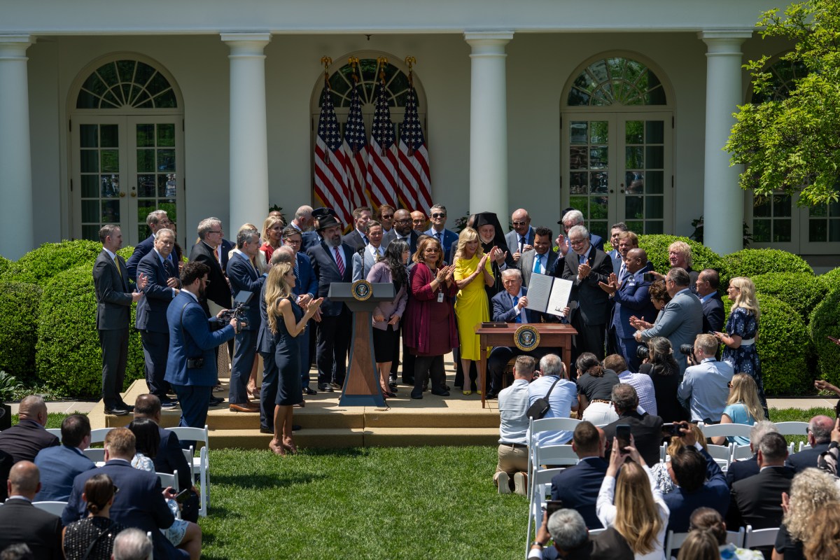 President Donald Trump signs an Executive Order alongside religious leaders at a National Day of Prayer event, Thursday, May 1, 2025, in the White House Rose Garden. (Official White House Photo by Joyce N. Boghosian)