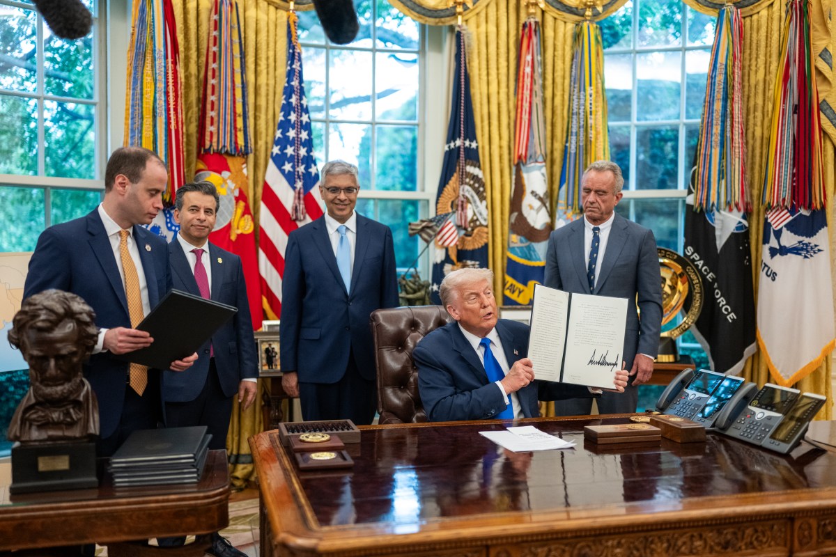 President Donald Trump signs executive orders flanked by Secretary of Health and Human Services Robert F. Kennedy, Jr. and Director of the National Institutes of Health Jay Bhattacharya, Monday, May 5, 2025, in the Oval Office. (Official White House Photo by Molly Riley)