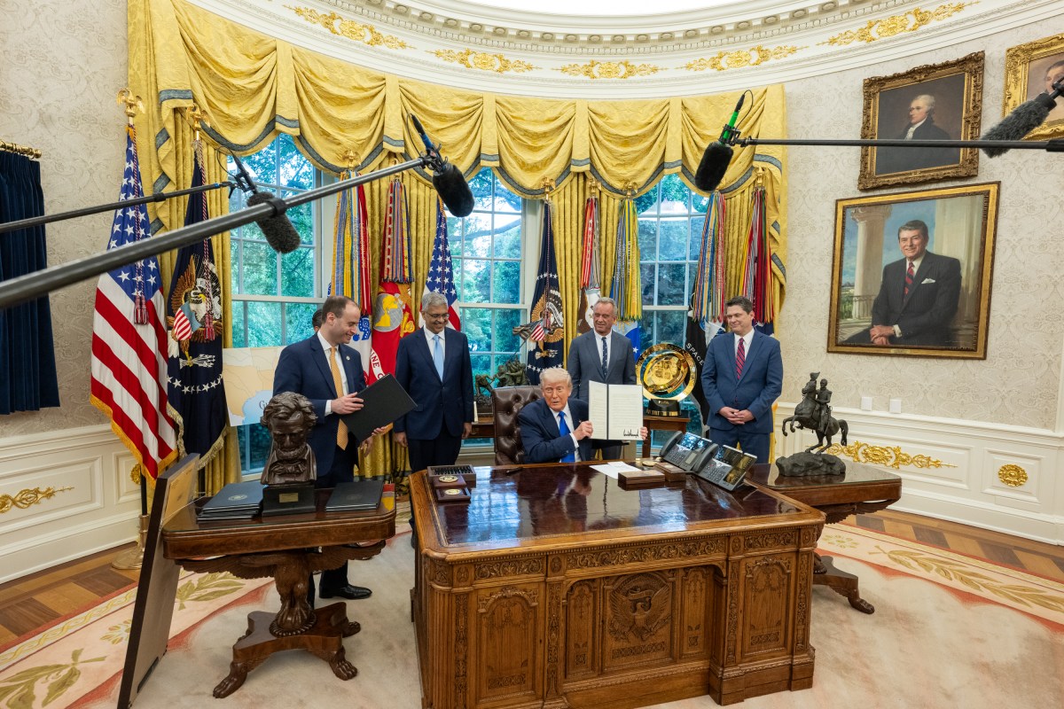 President Donald Trump signs executive orders flanked by Secretary of Health and Human Services Robert F. Kennedy, Jr. and Director of the National Institutes of Health Jay Bhattacharya, Monday, May 5, 2025, in the Oval Office. (Official White House Photo by Molly Riley)